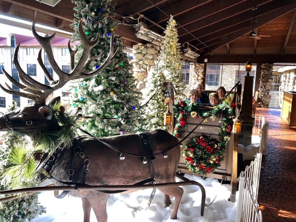 Great Falls Travel guests seated in a decorated Christmas sleigh at the Omni Grove Park Inn