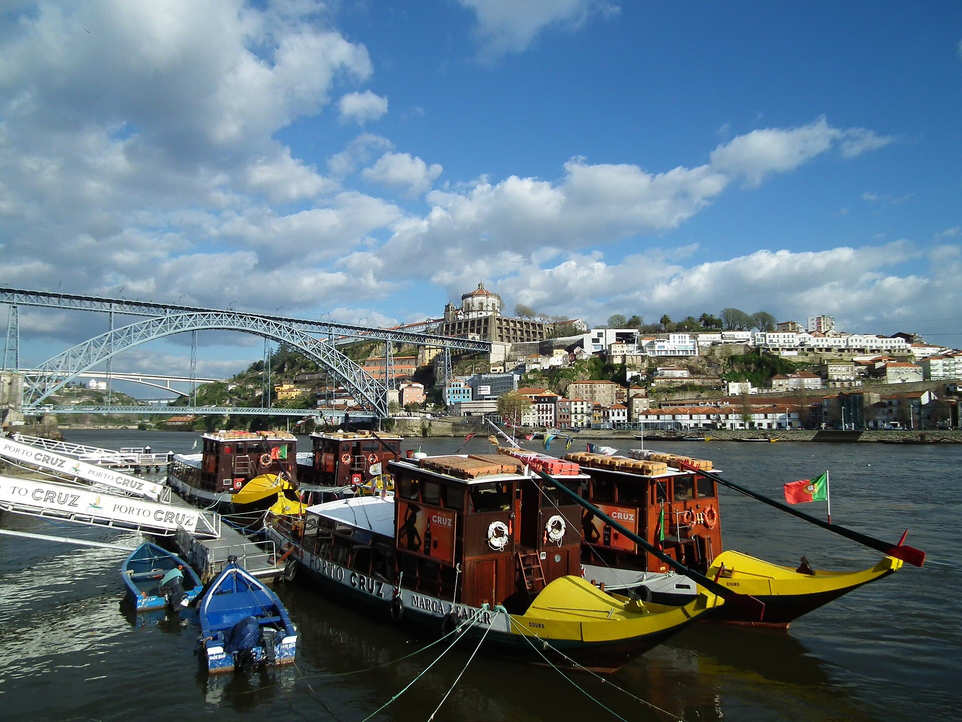 Traditional rabelo boats moored on the Douro River with the Dom Luís I Bridge behind