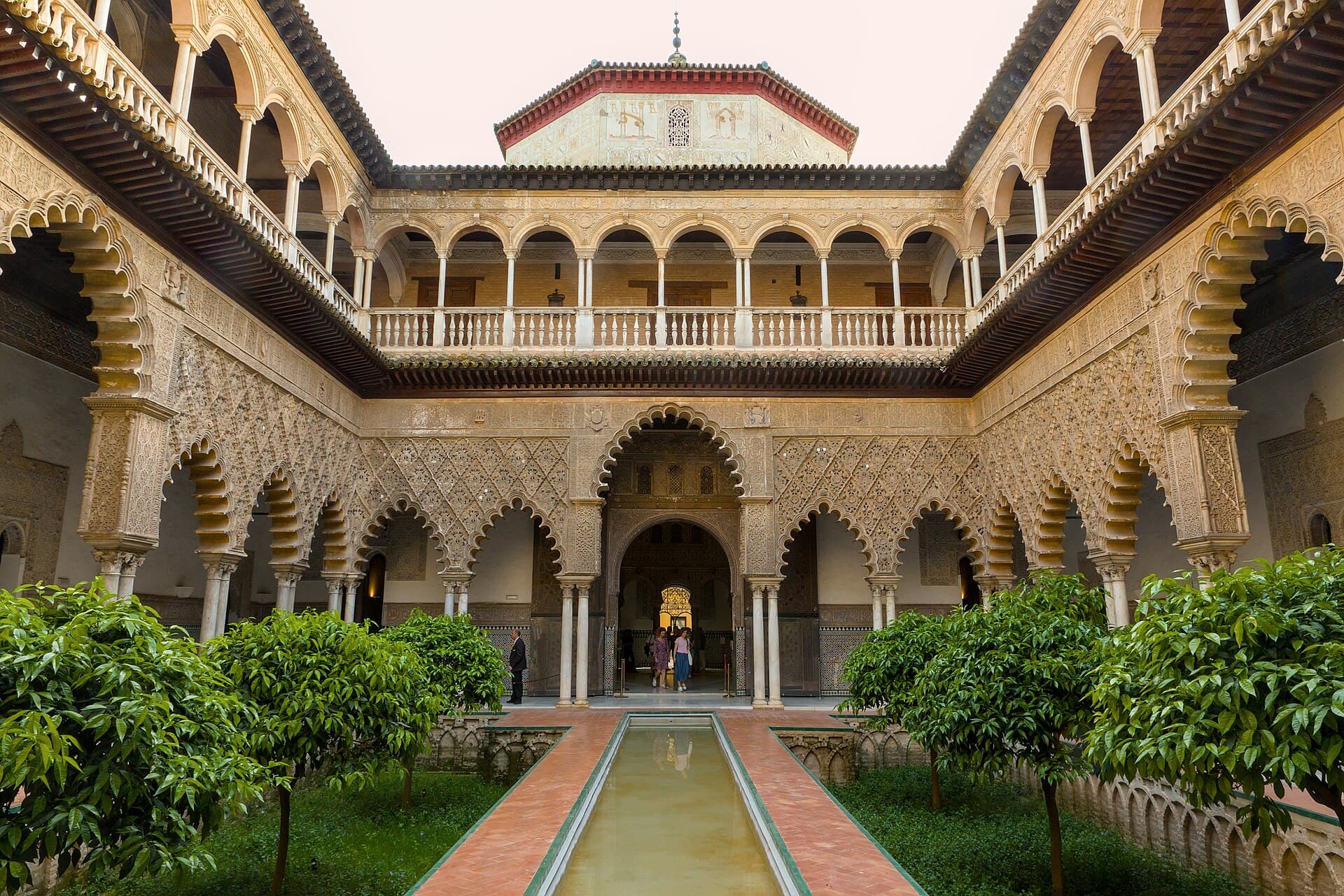 The tiled arches and reflecting pool of the Patio de las Doncellas in Seville’s Real Alcázar